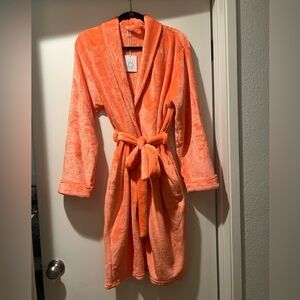 Plush bathrobe with embossed seashell on back.